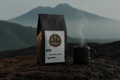 Grenade Coffee Medellín Operator Colombian single origin medium roast bag on volcanic stone with Andes mist background