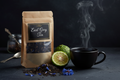 Grenade Coffee Earl Grey Tea premium loose leaf kraft pouch with blue cornflowers and bergamot on dark slate