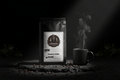 Grenade Coffee Takengon Reaper Sumatra single origin dark roast bag in dramatic spotlight lighting on volcanic stone